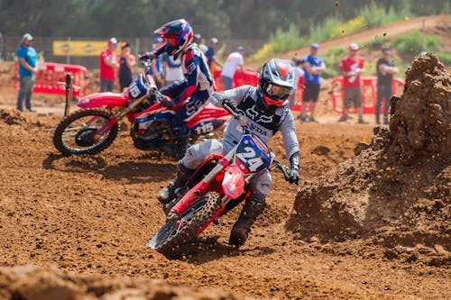 Free Two Men Riding Dirt Bikes on a Dirt Road Stock Photo