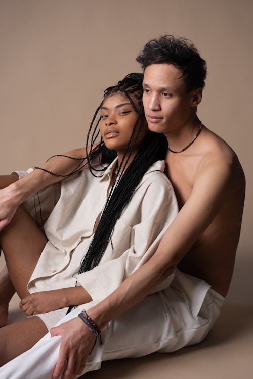 Woman With Dreadlocks Leaning On A Shirtless Man