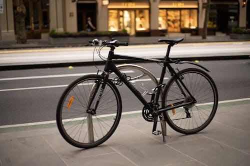 Black Road Bike Parked on the Sidewalk