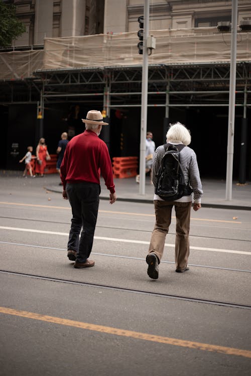 People Walking on the Asphalt Road