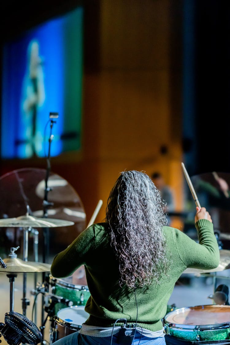 Unrecognizable Drummer Playing Drum Kit During Concert