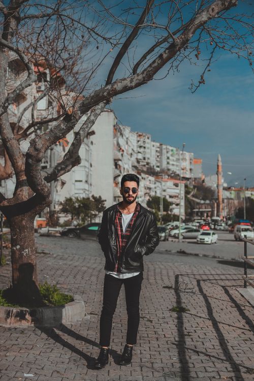 Free Stylish man standing in Gemlik, Turkey wearing sunglasses and black leather jacket. Stock Photo