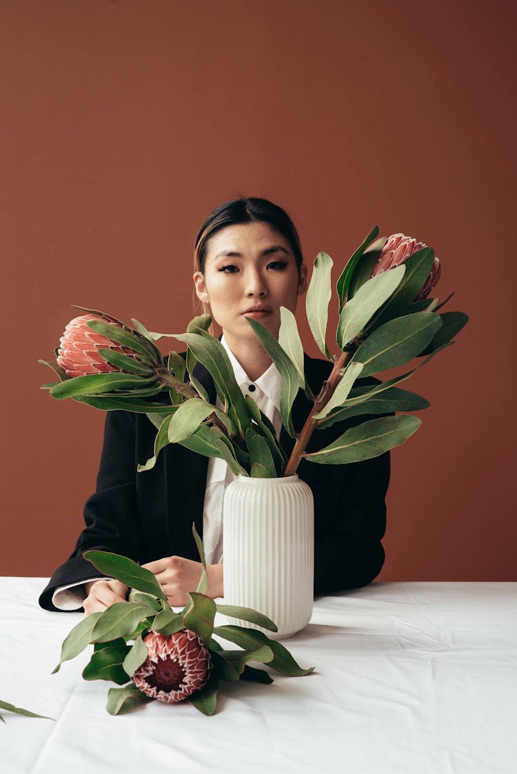 Asian Woman Near Protea Flowers