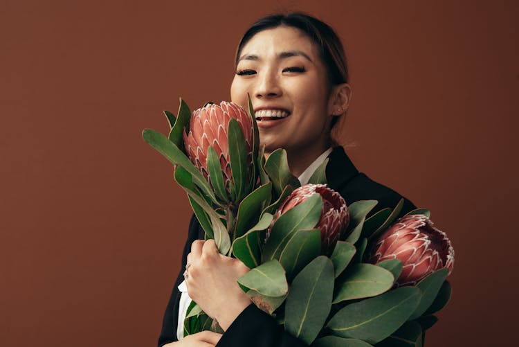 Happy Asian Woman With Flowers