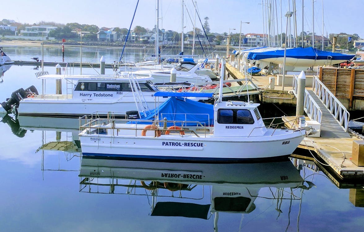 White Patrol-rescue Boat Near Brown Wooden Sea Dock