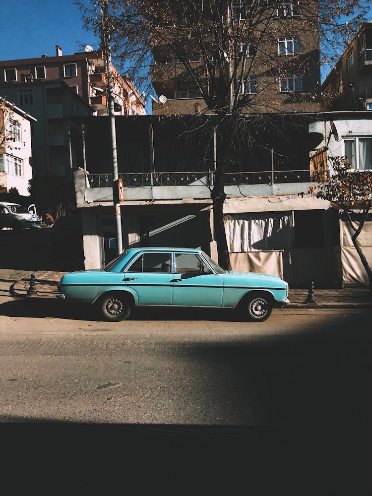 Vintage Car Near Shabby Building