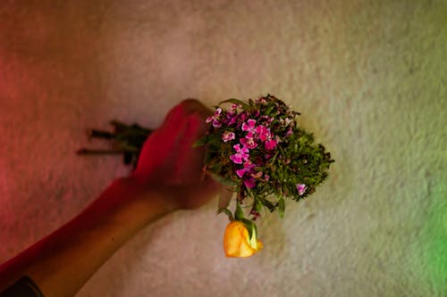 Anonymous person with bouquet of flowers