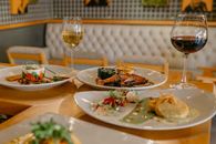 Table served with assorted appetizing dishes and wineglasses