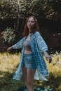 Dreamy young woman dancing with closed eyes on meadow