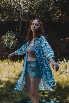 Dreamy young woman dancing with closed eyes on meadow
