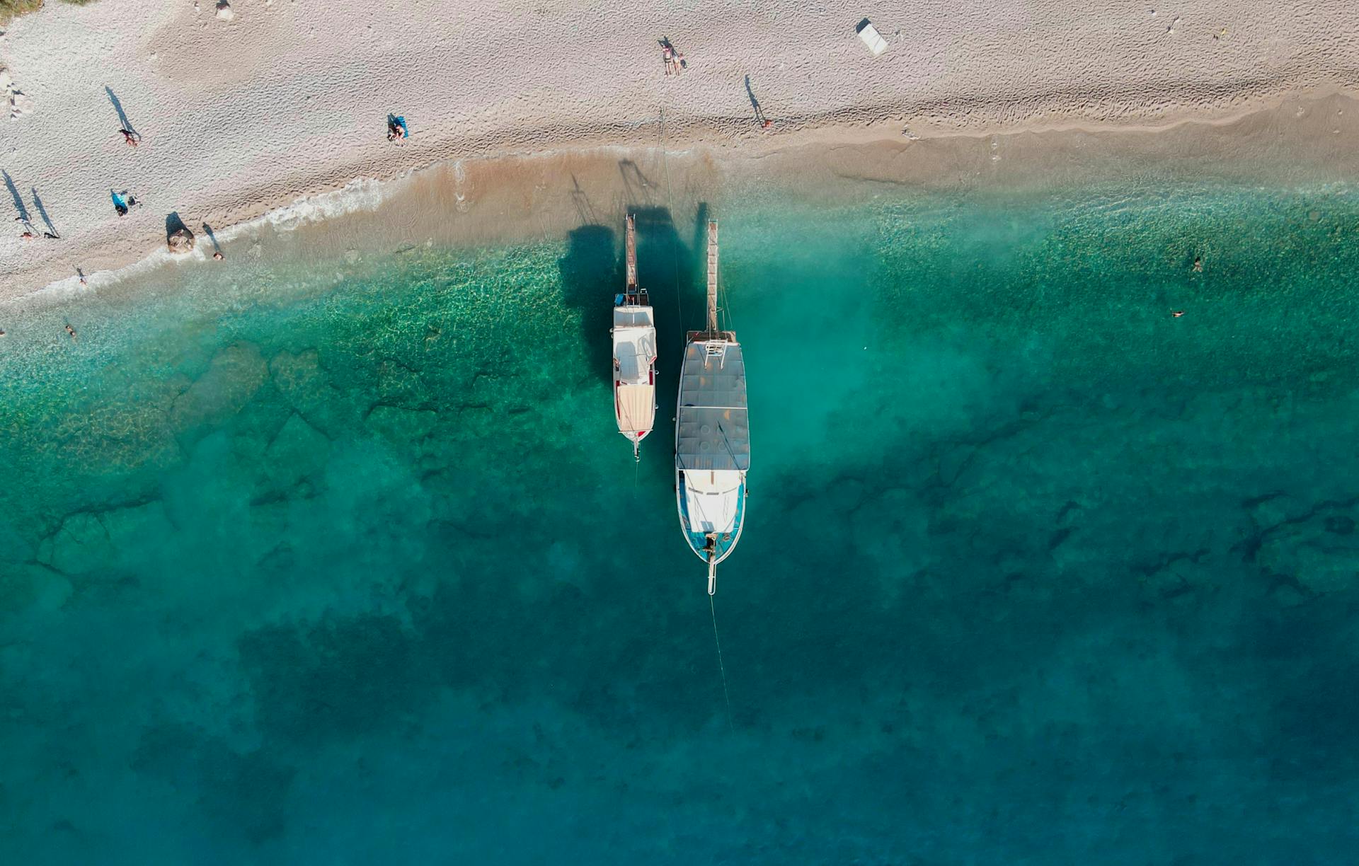 Stunning aerial view of boats anchored on turquoise waters near Fethiye Beach, Turkey.