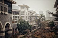 White Concrete Building Near the Green Trees