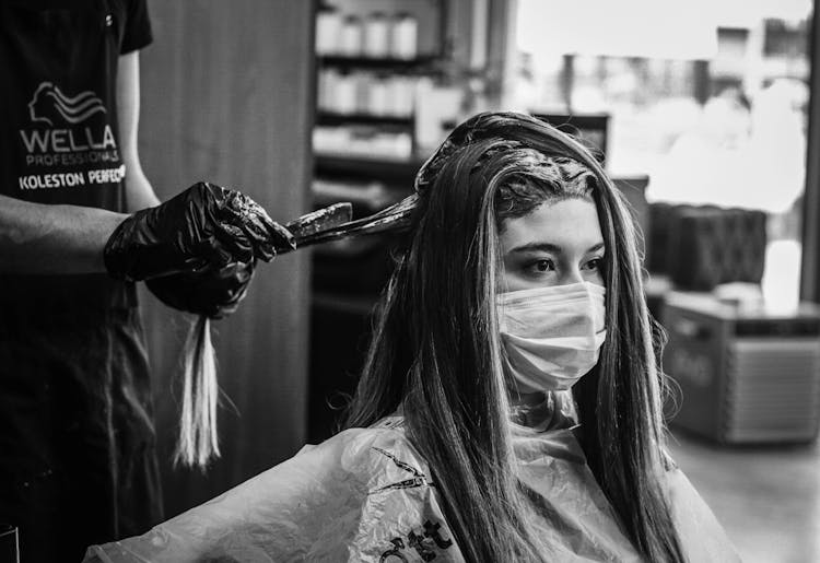 A Woman Wearing A Face Mask Getting A Hair Spa