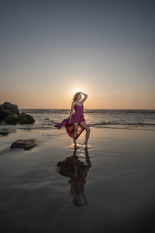 Woman Posing in Sea Water at Dusk