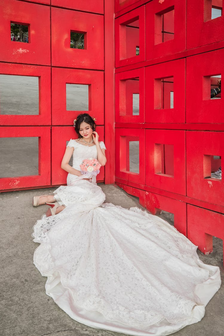 A Woman Wearing A Wedding Gown With A Long Train