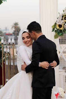 Bride and groom embrace during outdoor wedding ceremony, exuding joy and love.