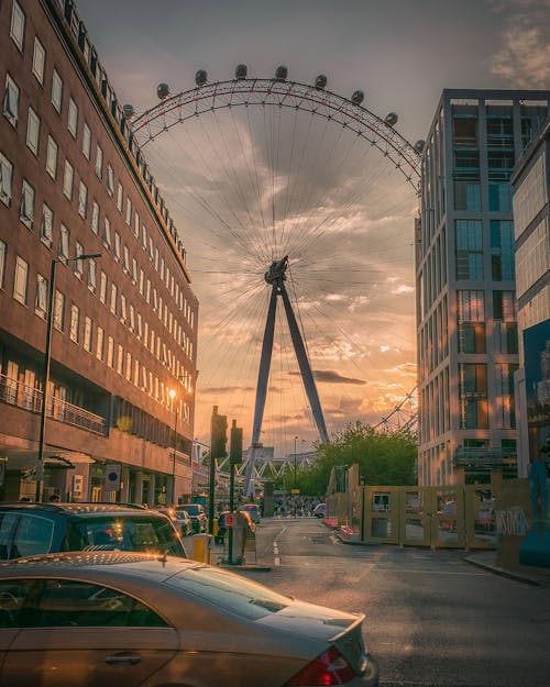 Ferris Wheel Near Building during Sunset