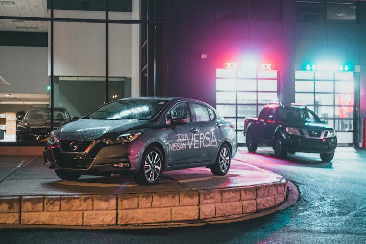 Modern Black Automobiles In Car Showroom