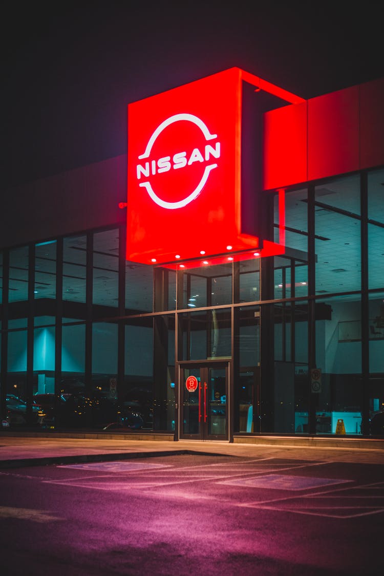 Auto Show Building With Shining Signboard In Evening