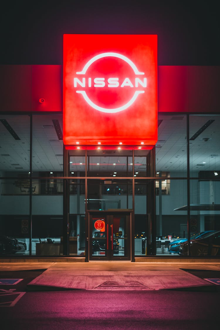 Entrance Of Car Dealership With Red Signboard At Night