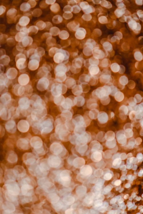 Free Captivating abstract bokeh background with warm golden tones creating a mesmerizing effect. Stock Photo