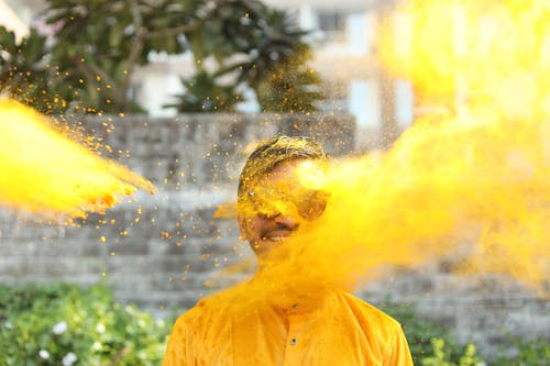 A man in Yellow Dress Splash with Yellow Paint