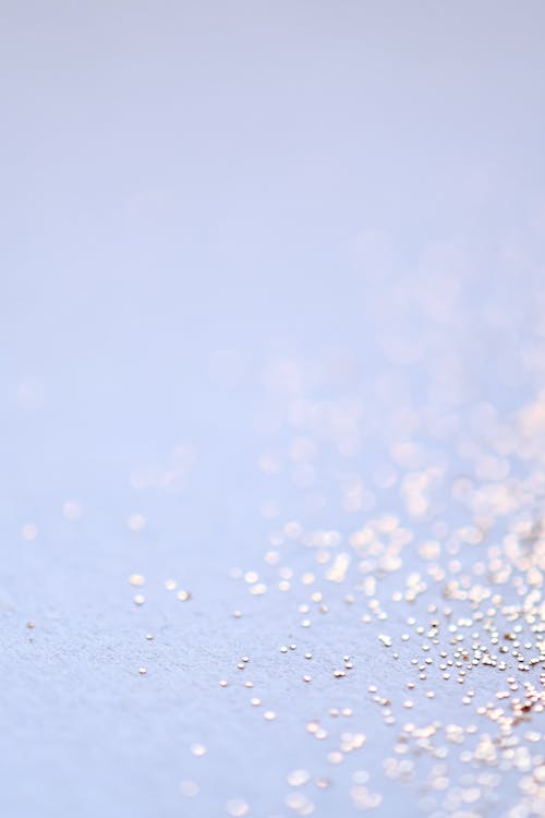 Silver Glitters on a White Surface