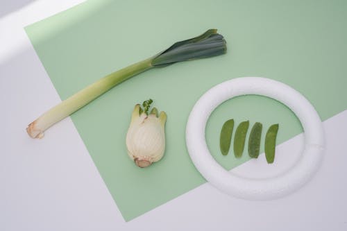 Fresh Vegetables over White and Green Surface