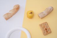 Yellow Apple Fruit Beside Bread on White Table