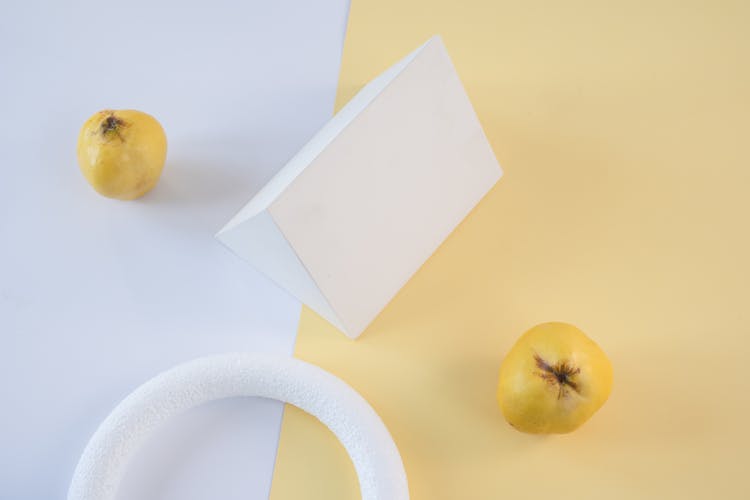 Quince Fruits Beside Geometric Shape Figures