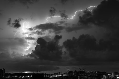 Free Captivating black and white scene of a stormy Guangzhou skyline illuminated by lightning. Stock Photo