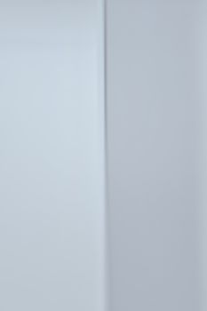 Close-up of a minimalistic white wall surface offering a sleek modern background.