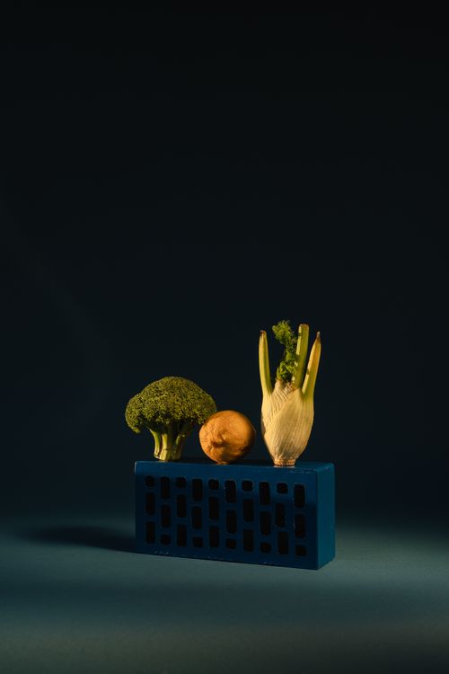 Free Still life photo of broccoli, fennel, and lemon on a blue brick with dark background. Stock Photo