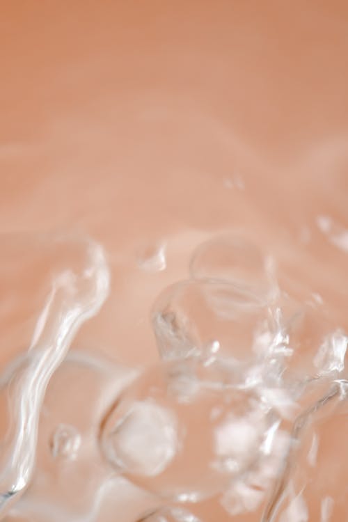 Free Water Droplets on Peach Surface Stock Photo