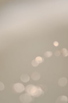Soft abstract bokeh image featuring subtle light patterns and blurred shapes, creating a calming effect.