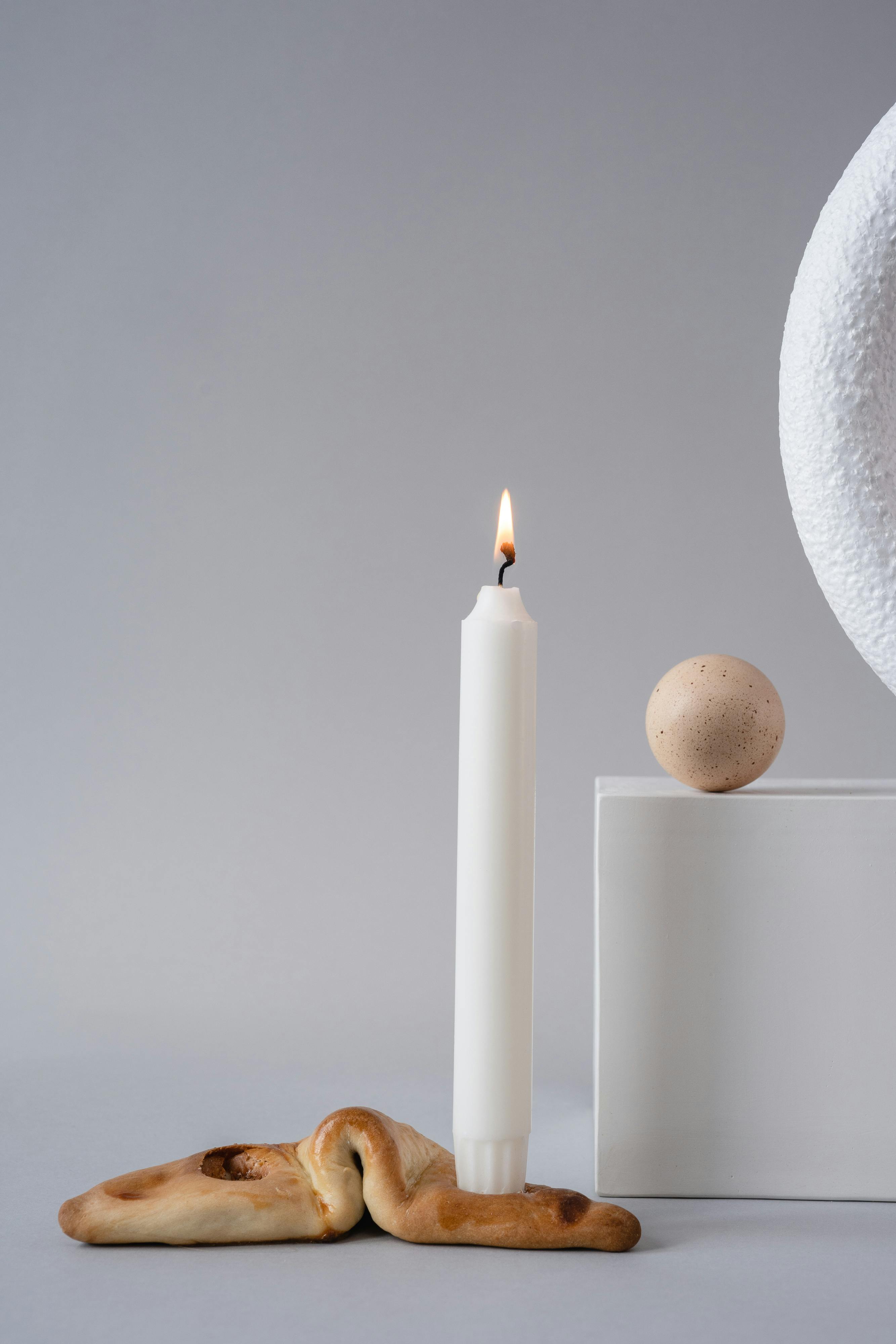 White Lighted Candle on a Bread · Free Stock Photo