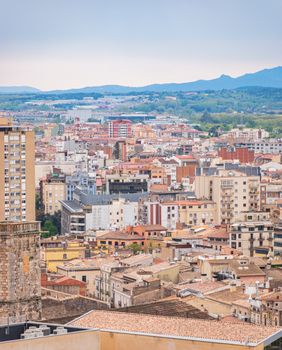 A stunning aerial view of Girona, showcasing its vibrant urban architecture against a scenic backdrop.