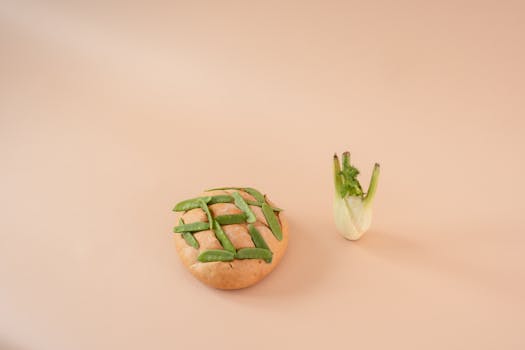 Creative display of bread with green peas and fennel on beige background.