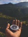 Person Holding Silver and Black Round Case