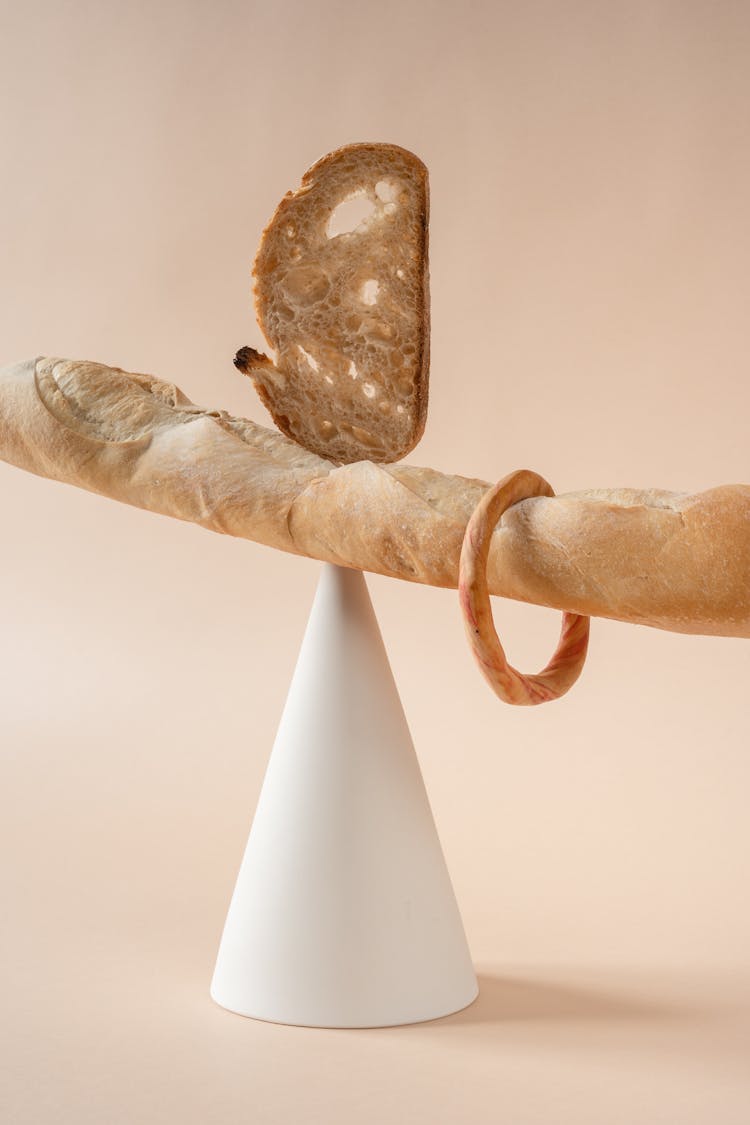 Different Breads Balanced On A Triangle Stand