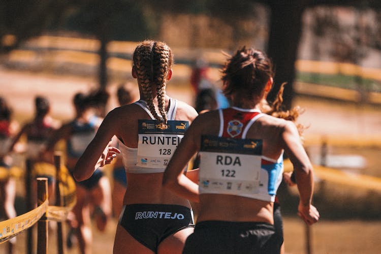 Back View Of Female Runners In A Marathon Event