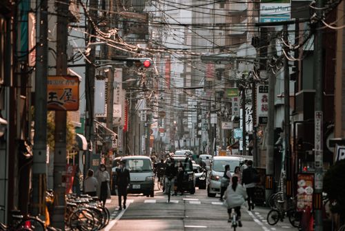 Free Busy street scene in Osaka, Japan showcasing urban life with people and vehicles. Stock Photo