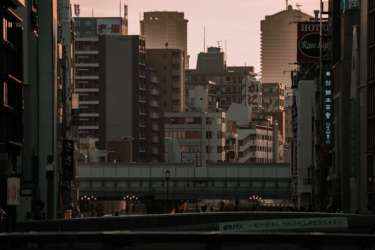 cityscape of osaka s business district with towering buildings at suns