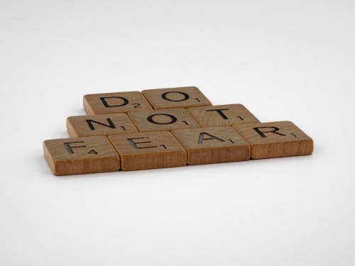 Wooden Letter Tiles on the White Surface