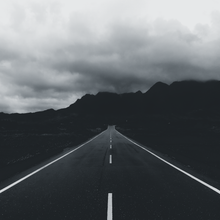 Late Drive Anthems playlist cover — mountain road photo by Laros Lin on Pexels