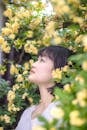 Side Profile of a Beautiful Woman Near Yellow Flowers