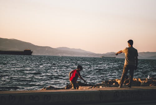 Free stock photo of father and son, sea, sunset landscape