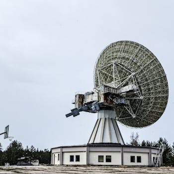 A large satellite dish used for communication and astronomy in an outdoor setting.