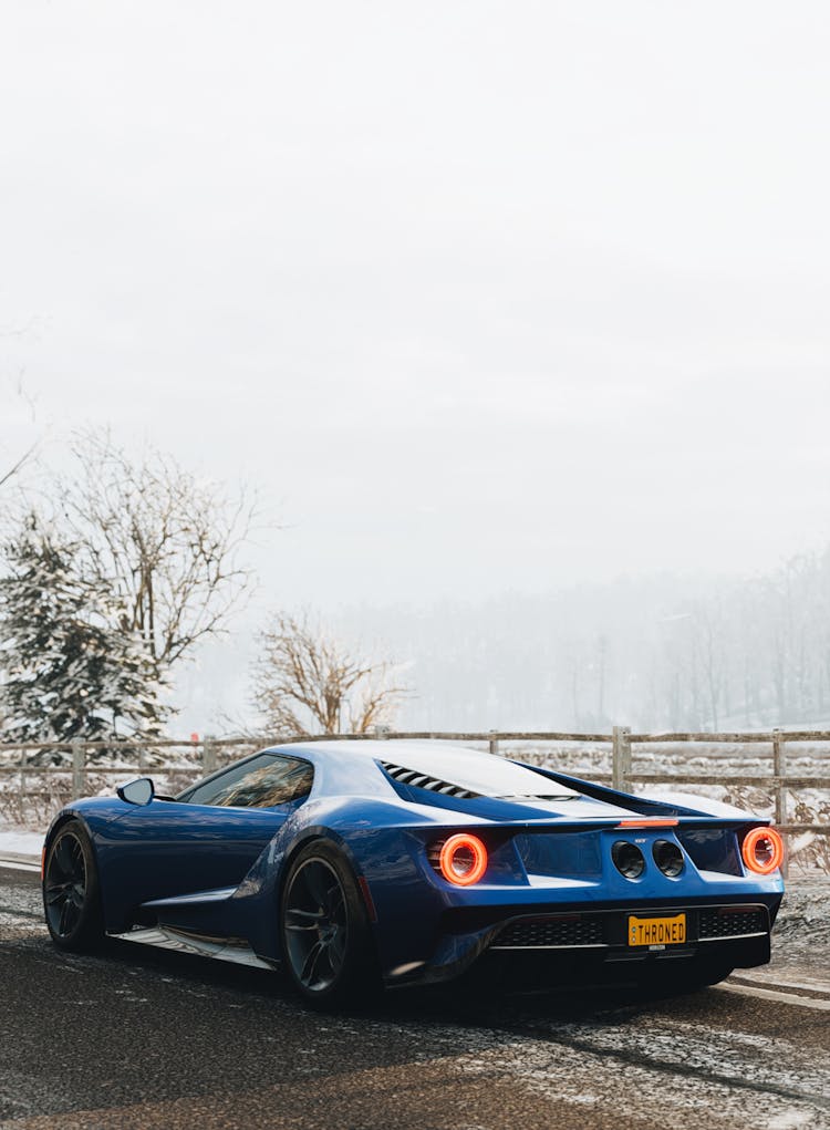 
A Blue Supercar At The Side Of A Road