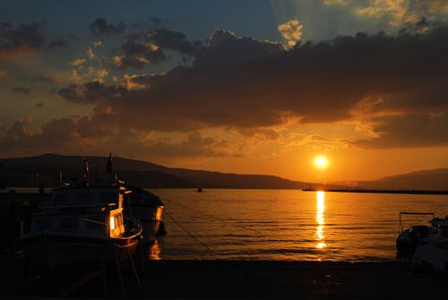 Free stock photo of boat, golden sunset, sea